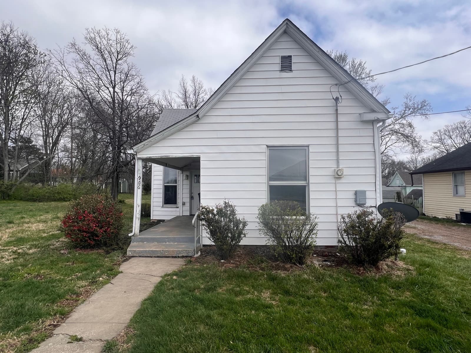 Small white one-story house with a covered side porch