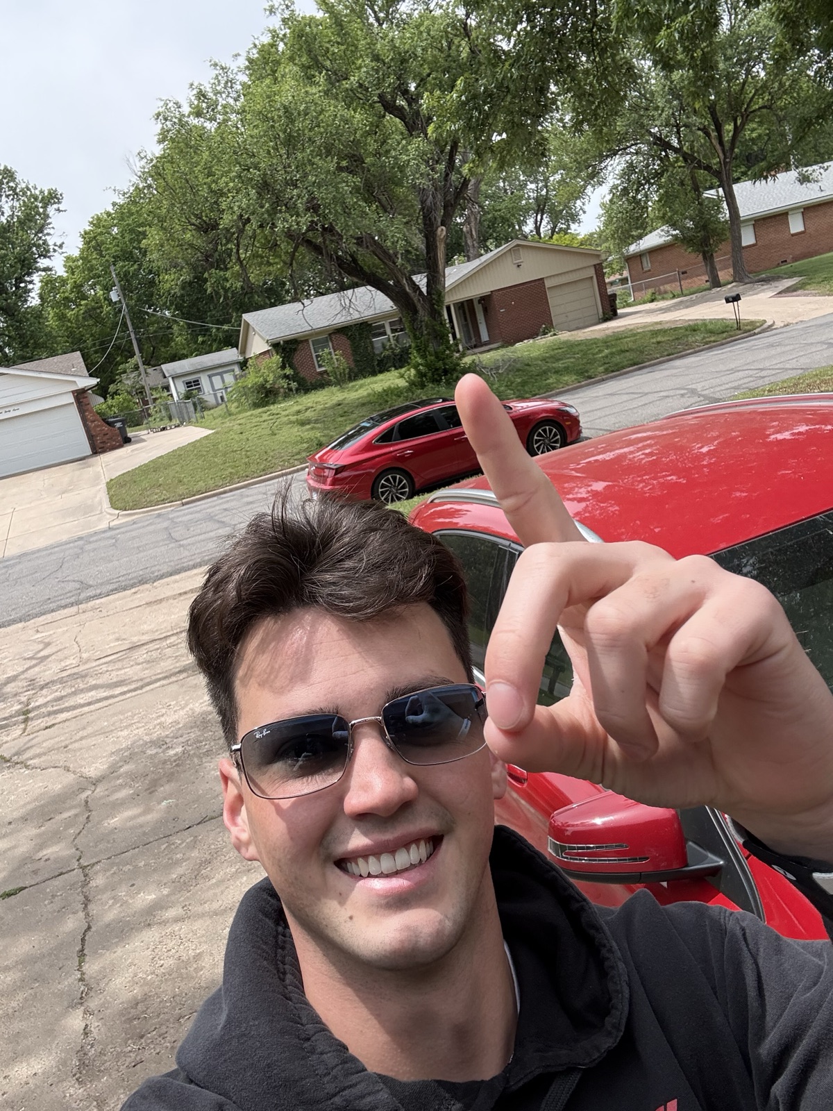 Brayden Myers, founder of We Buy Houses Columbia, in front of a recently purchased home in Columbia, MO